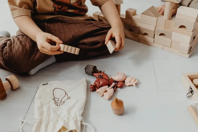Toddler playing with colourful learning toys